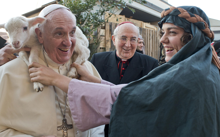 A woman dressed as a character from a Nativity scene puts a lamb around the neck of Pope Francis as he arrives to visit the Church of St. Alfonso Maria dei Liguori on Monday in Rome. (CNS/Reuters/L'Osservatore Romano)