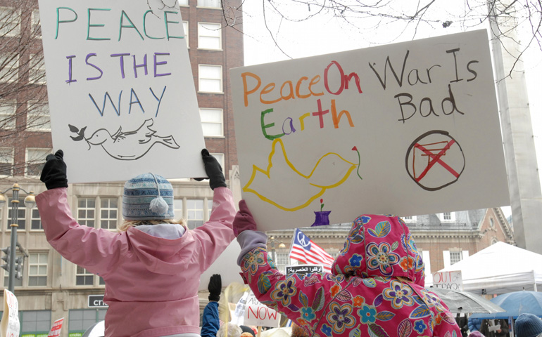 Children take part in a protest marking the fifth anniversary of the war in Iraq in March 2008 at the Liberty Pole in Rochester, N.Y. (CNS/Catholic Courier/Mike Crupi)