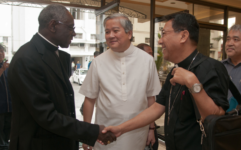 Archbishop Socrates Villegas, center, watches Palo Archbishop John Du, right, meet Cardinal Robert Sarah, president of Pontifical Council Cor Unum, during the last day of the Philippines bishops' plenary assembly Jan. 27 in Manila, Philippines. (Roy Lagarde)