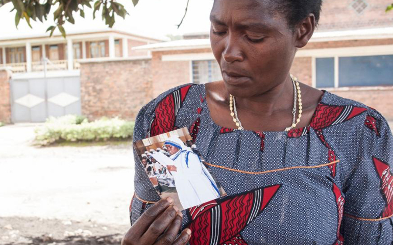 Sister Reginette's mother holds a photo of her daughter, whom she had tried to convince to return home. (GSR/Lilian Muendo)