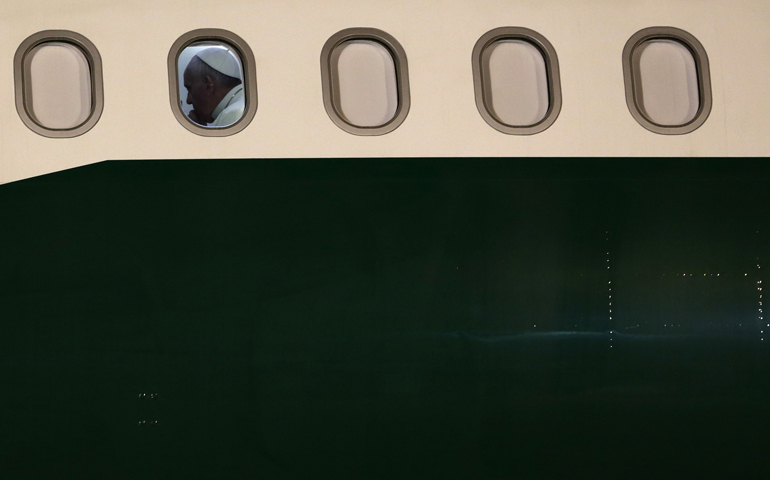 Pope Francis is seated at a window of his plane Sunday before it departs Rio de Janeiro. (CNS/Reuters/Ricardo Moraes)
