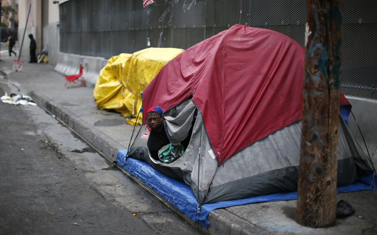 A man wakes up after sleeping in a tent on downtown Los Angeles' Skid Row in early March. (CNS/Reuters/Lucy Nicholson)