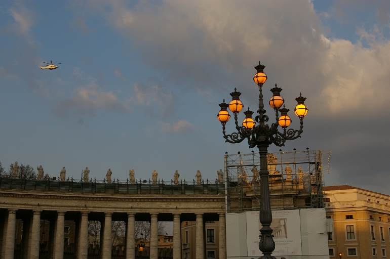 The helicopter carrying Pope Benedict to Castel Gandolfo passes over the northern colonnade in St. Peter's Square. (NCR photo/Joshua J. McElwee)
