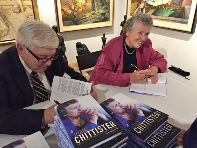 Tom Roberts, author of a biography of Benedictine Sr. Joan Chittister released Oct. 1, sign books with her at a launch event at Pucker Gallery in Boston. (GSR/Caitlin Hendel)