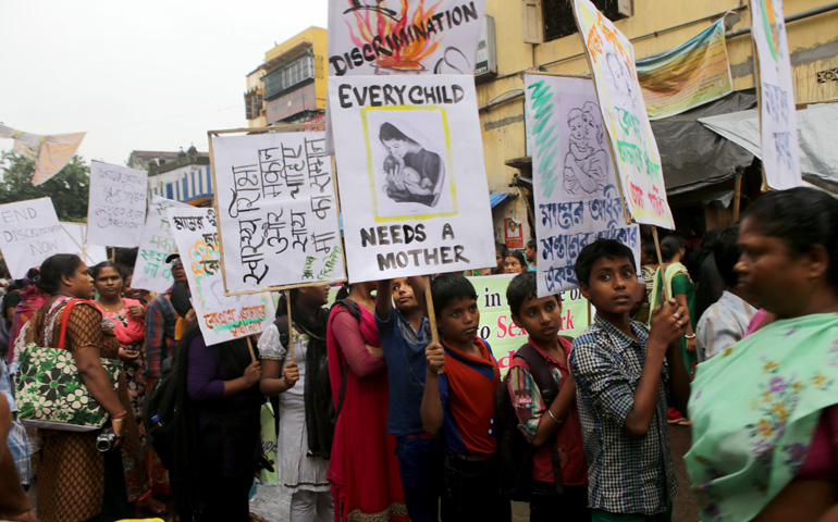 Sex workers and their children take part in an Aug. 14 demonstration seeking better rights and a halt to girl trafficking in the red-light area of Kolkata, India. (CNS/EPA/Pial Adhikary)