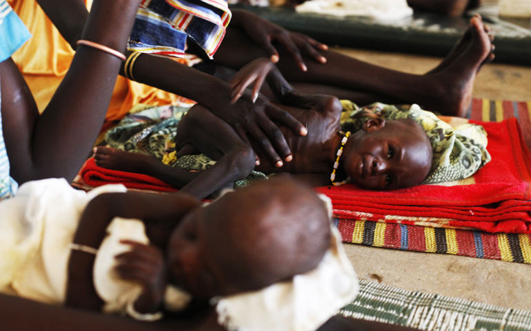 Malnourished children lie next to their mothers July 15 at the Medecins Sans Frontieres Hospital in Leer, South Sudan. (CNS/Reuters/Andreea Campeanu)