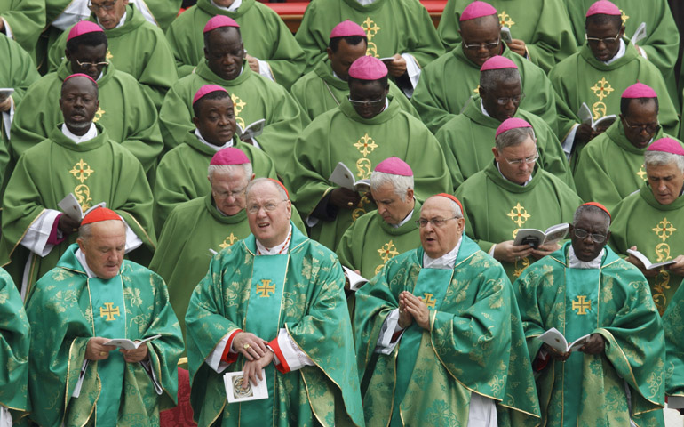 Cardinals and bishops attend the opening Mass of the Synod of Bishops on the new evangelization celebrated by Pope Benedict XVI on Oct. 7 in St. Peter's Square at the Vatican. In the first row are Cardinals Kazimierz Nycz of Warsaw, Timothy M. Dolan of New York, Leonardo Sandri, and Robert Sarah. (CNS/Paul Haring)