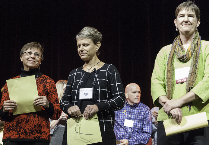 Three fired church workers stand after reading the "Catholic Church Worker Declaration" at the Call to Action meeting in Milwaukee Nov. 8. From left are Ruth Kolpack of Beloit, Wis., Kristen Ostendorf of St. Paul, Minn., and Margie Winters of Philadelphia. (Tom Boswell)