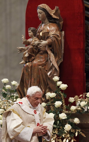 Pope Benedict XVI walks past a statue of Jesus and Mary as he celebrates Mass in St. Peter's Basilica at the Vatican Jan. 1. (CNS/Paul Haring) 
