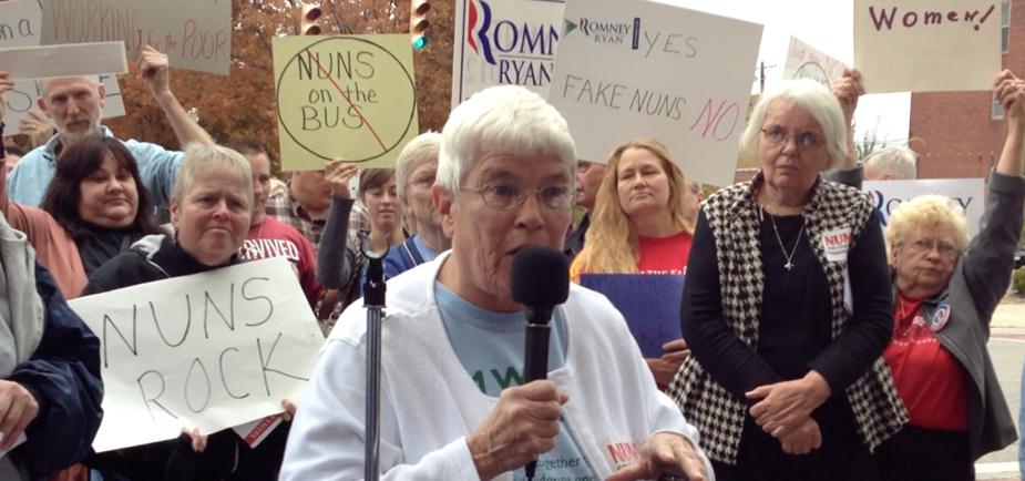 Dominican Sr. Monica McGloin speaks during a Nuns on the Bus stop Oct. 15 in Marietta, Ohio, as both supporters and protesters hold signs behind her. (Nuns on the Bus)
