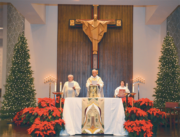 From left, Deacon Dan Finn, Fr. John Dillon and Meghan Jones lead the feast of the Epiphany liturgy at St. Francis of Assisi Church Jan. 6 in Derwood, Md. (Photo by Elizabeth Demaree)