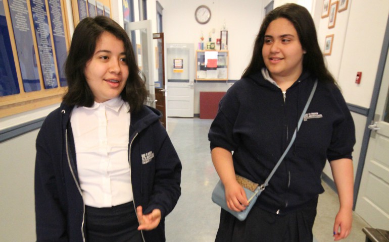 Elizabeth and her best friend, Evangelina Tapio, eighth-graders at St. Andrew Nativity School in Portland, Ore., walk to class May 2. (CNS photo/Katie Scott, Catholic Sentinel) 