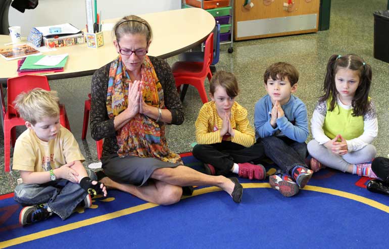 Pre-kindergarten teacher Patricia Batus prays with her students at Long Beach Catholic Regional School in Long Beach, N.Y., Nov. 15. Classes resumed at the school Nov. 14, more than two weeks after it was closed when Hurricane Sandy caused severe destruc tion to Long Beach and other communities in the Northeast. (CNS photo/Gregory A. Shemitz, Long Island Catholic)