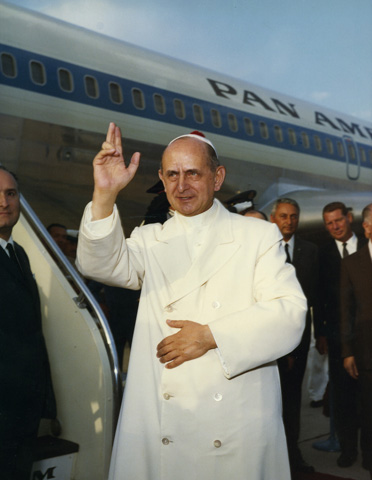 Pope Paul VI offers a blessing at Rome's Leonardo da Vinci airport before boarding a flight to Istanbul, Turkey, in 1967. (CNS file photo) 