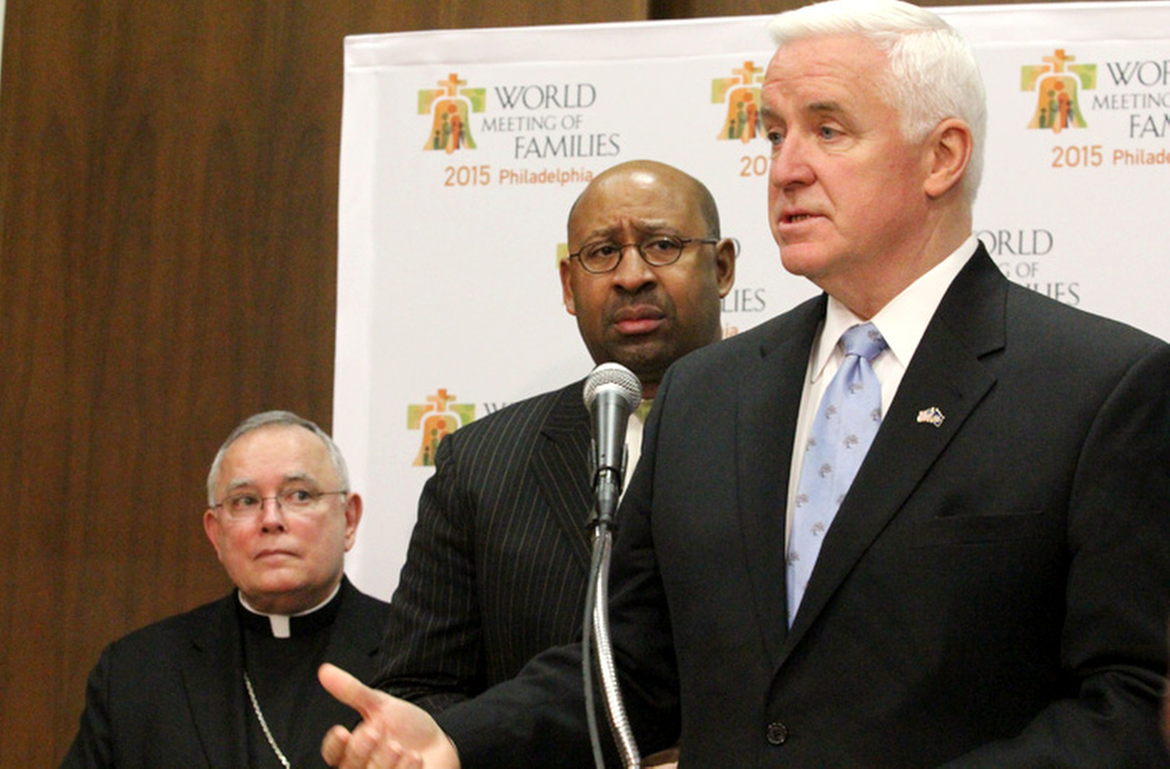 Archbishop Charles J. Chaput of Philadelphia and Philadelphia Mayor Michael Nutter look on as Pennsylvania Gov. Tom Corbett address the media during a March 7 news conference in Philadelphia. Nutter was announcing that they are leading a delegation to th e Vatican later in the month to meet with officials about plans for the World Meeting of Families in 2015, taking place in Phialdelphia. (CNS photo/Sarah Webb, CatholicPhilly.com) (March 7, 2014)