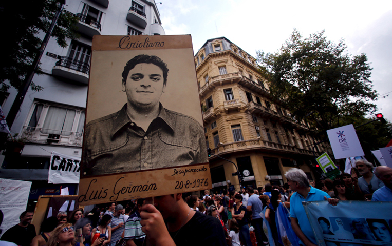A man holds up a portrait of Luis German Cirigliano, who disappeared during Argentina’s “Dirty War,” during a demonstration to commemorate the 40th anniversary of the 1976 military coup in Buenos Aires, on March 24, 2016. (Reuters/Marcos Brindicci)