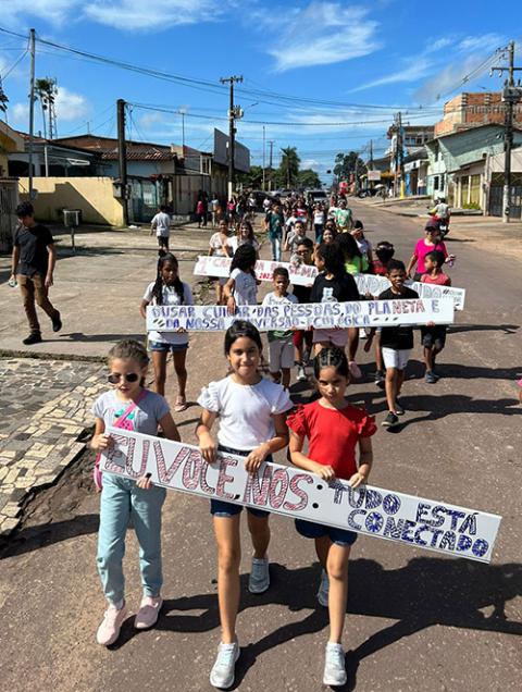 Children in Pará, Brazil, in the Amazon rainforest, lead a walk as part of the 2023 Run4Unity. Later, the 60-plus participants planted a banana tree. (Lore Cabral)