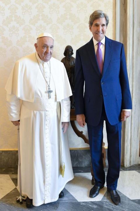 Pope Francis poses for a photo with John Kerry, U.S. President Joe Biden's special envoy for climate issues.