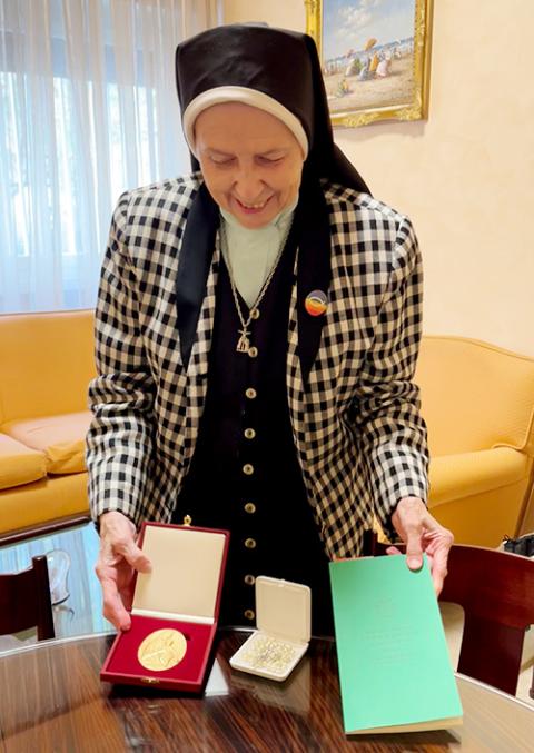 Loretto Sr. Jeannine Gramick poses with items given to her by Pope Francis on Oct. 17. (NCR photo/Joshua J. McElwee)