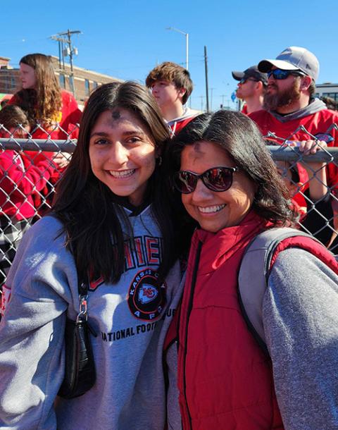 Christine Reynoldson, left, and her mother, Gina Sanchez, attend the Kansas City Chiefs Super Bowl parade in downtown Kansas City, Missouri, on Feb. 14. (NCR photo/Brian Roewe)
