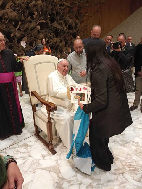 The Rev. Andrea Conocchia, center, introduces members of the Torvaianica transgender community to Pope Francis on Aug. 11, 2022, during the pope’s general audience at the Vatican. (Photo courtesy of Andrea Conocchia)