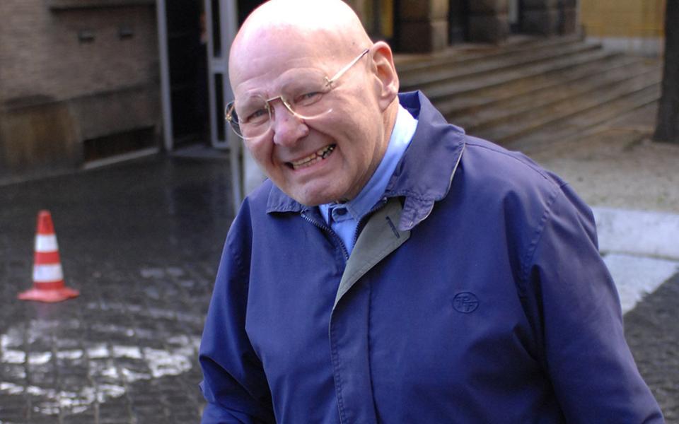 Wearing his trademark blue workman’s uniform, Discalced Carmelite Fr. Reginald Foster is photographed near the Vatican post office in this January 2007 file photo. (CNS/Chris Warde-Jones)