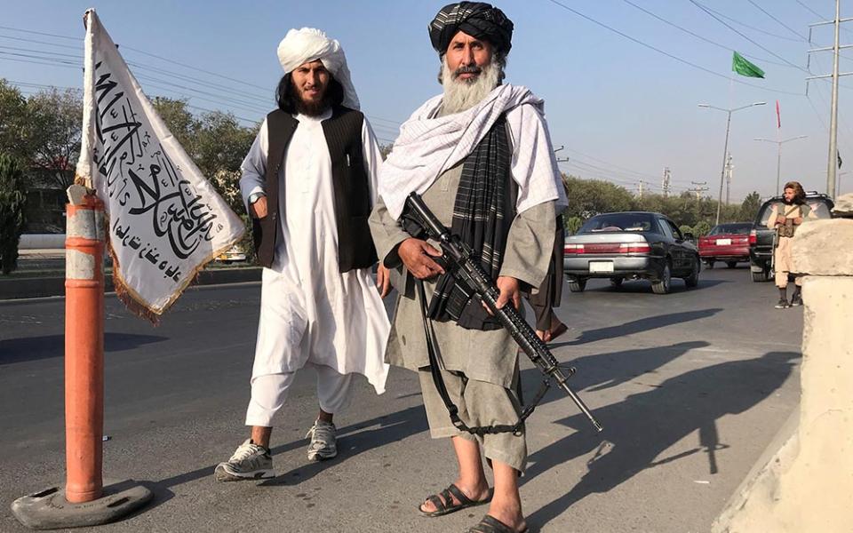 Taliban fighters stand outside the Interior Ministry in Kabul, Afghanistan, Aug. 16. (CNS/Reuters)