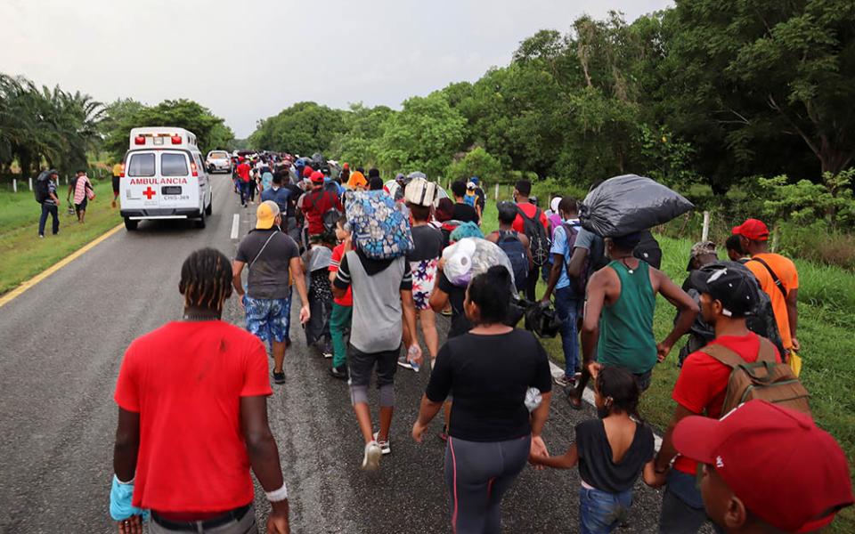 Migrants from Central America and the Caribbean walk in a caravan near Escuintla, Mexico, Aug. 29. They were headed to Mexico City to apply for asylum and refugee status. (CNS/Reuters/Jose Torres)