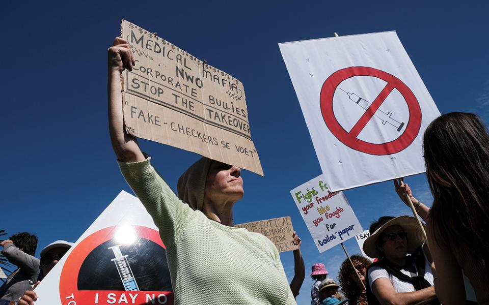 Anti-vaccine protesters hold placards during a march against COVID-19 vaccinations Sept. 18 in Cape Town, South Africa. (CNS/Reuters/Mike Hutchings)