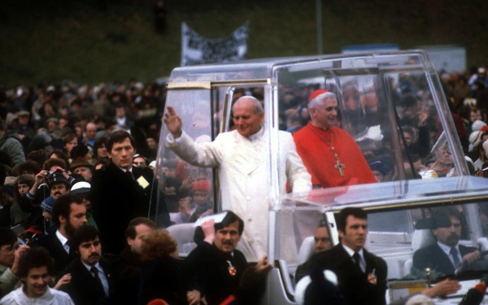 St. John Paul II and Cardinal Joseph Ratzinger ride in the popemobile during a visit to Germany in 1980. The cardinal -- now retired Pope Benedict XVI -- headed the Archdiocese of Munich 1977-1981. (CNS photo/KNA)