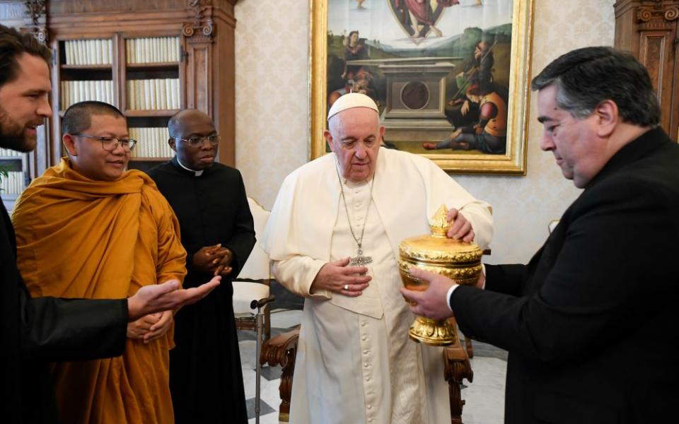 Pope Francis receives a gift from members of a delegation of Buddhists from Cambodia in the library of the Apostolic Palace at the Vatican Jan. 19, 2023. (CNS/Vatican Media)