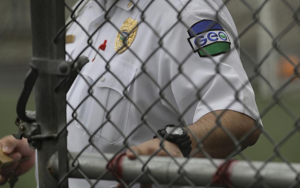 A patch is shown on the uniform of a guard with the GEO Group, Inc., during a media tour of the U.S. Immigration and Customs Enforcement detention center, Dec. 16, 2019, in Tacoma, Washington. The GEO Group is a private prison company that operates two central California immigration detention centers, where 82 people began a hunger strike Feb. 17. (AP photo/Ted S. Warren)