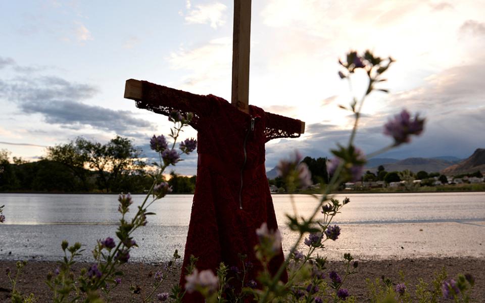 A child's red dress hangs on a stake near the grounds of the former Kamloops Indian Residential School in Kamloops, British Columbia June 5, 2021. For years Indigenous people in Canada have wanted an apology from the pope for the church's role in abuse at Catholic-run residential schools. (CNS/Reuters/Jennifer Gauthier)