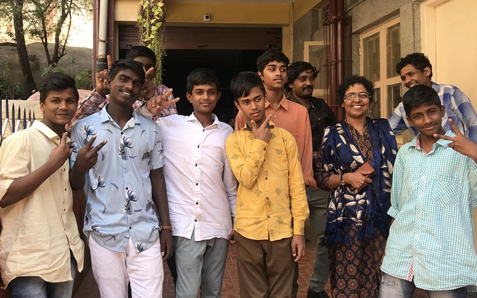 Anand and Ayyappan (far left) and their peers are pictured with Gleaners of the Church member Silvy Lawrence Pazherickal, in front of BOSCO Yuvakendra, a youth center for street children in Bengaluru, southern India. (Thomas Scaria)