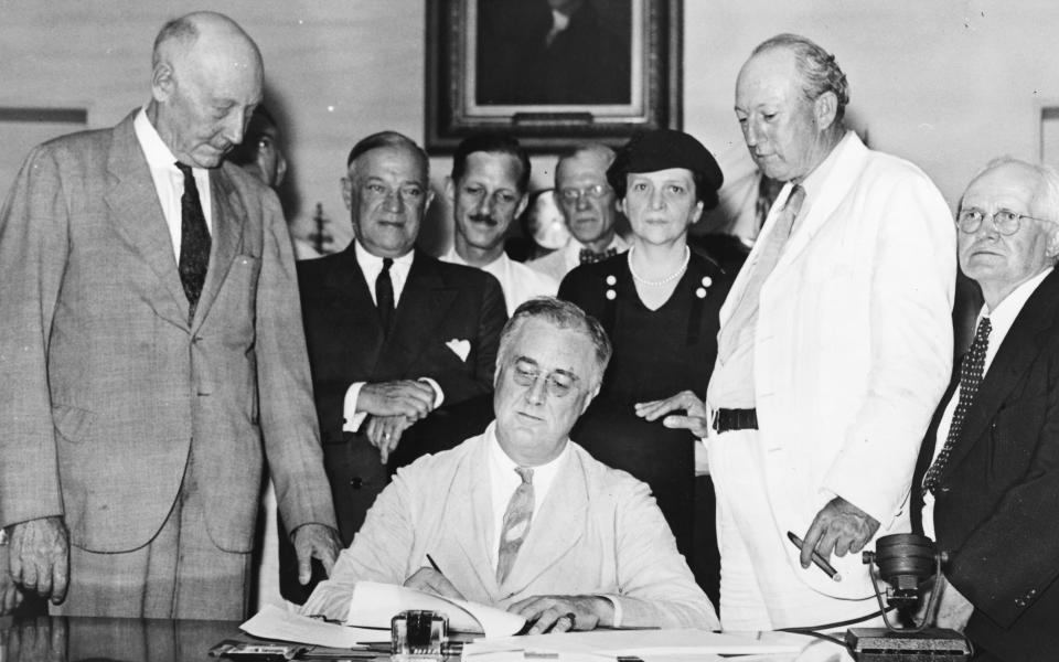 President Franklin D. Roosevelt signs the Social Security Act Aug. 14, 1935. It was one several programs Roosevelt enacted from 1933 to 1939 as part of the New Deal, intended to stabilize the country's economy and provide relief to American workers and fa