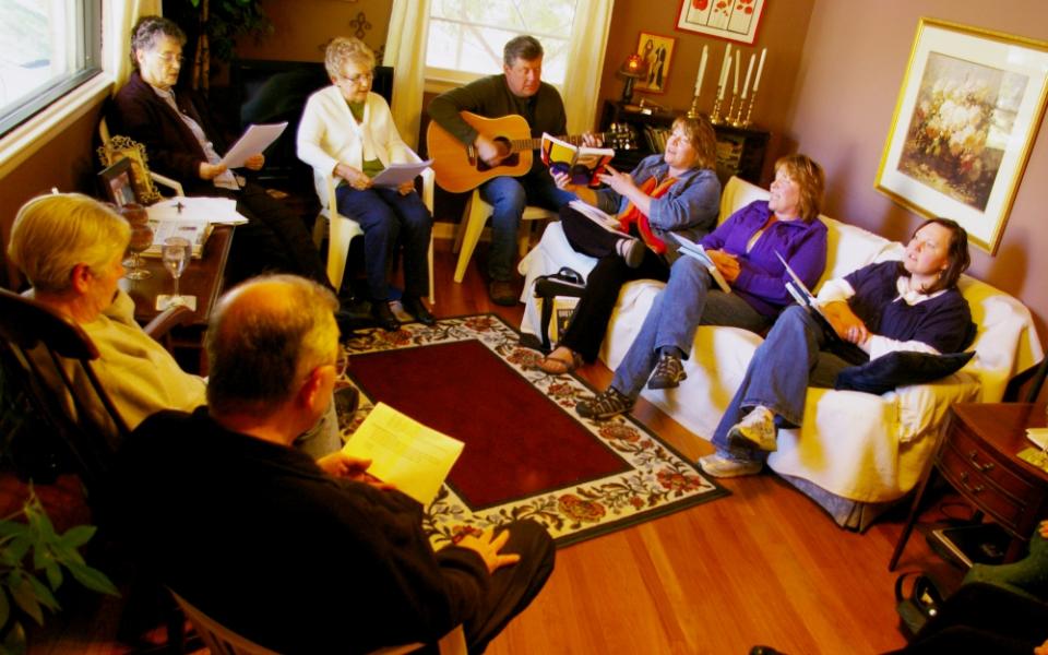 Members of the Call to Action group in Lincoln, Nebraska, sing in a prayer liturgy during a 2012 meeting at the home of Rachel Pokora. (NCR photo/Joshua J. McElwee)