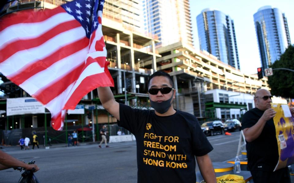 A fan wears a T-shirt supporting Hong Kong and holds a U.S. flag before an NBA game between the Los Angeles Lakers and the LA Clippers in that city Oct. 22. (Newscom/USA Today Sports/Kirby Lee)