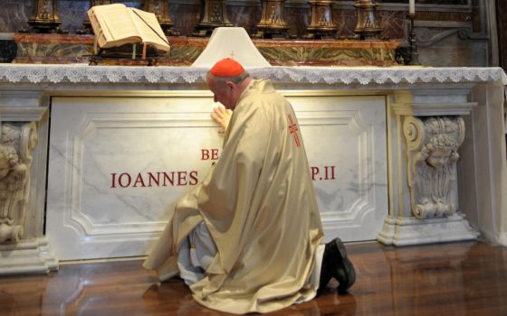Polish Cardinal Stanislaw Dziwisz prays at the tomb of St. John Paul II in St. Peter's Basilica at the Vatican in May 2011. (CNS/L'Osservatore Romano)