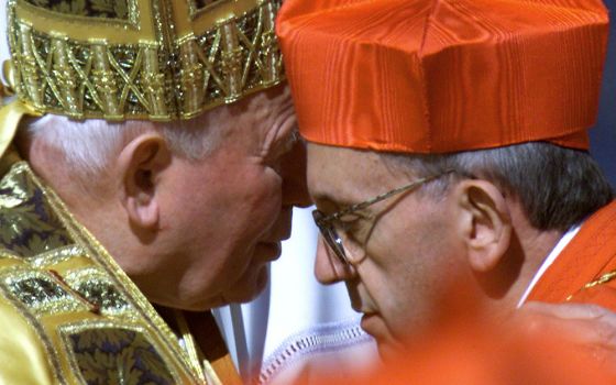 Pope John Paul II embraces Argentine Cardinal Jorge Bergoglio after presenting the new cardinal with a red beretta at the Vatican Feb. 21, 2001, setting the stage for the Bergoglio's later election as Pope Francis. (CNS/Reuters)