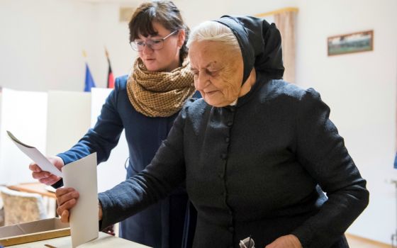 Women cast their votes Sept. 24 at a polling station in Crostwitz, Germany. (CNS/Reuters/Matthias Rietschel)