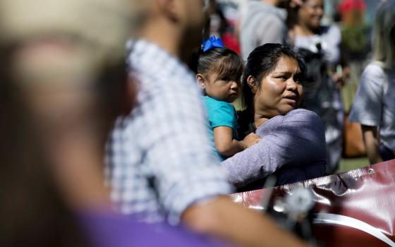 A woman holds a child during an immigration rally near the U.S. Capitol in Washington Sept. 26. (CNS/Tyler Orsburn)