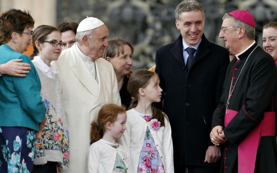 Pope Francis talks with Dublin Archbishop Diarmuid Martin as he meets an Irish delegation of families during his general audience in St. Peter's Square at the Vatican March 21. (CNS/Paul Haring)