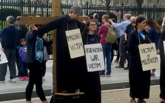 Faith and Resistance retreatants participate in a Good Friday public witness in front of the White House in Washington, D.C., March 30 to protest "contemporary crucifixion." (Lin Romano)