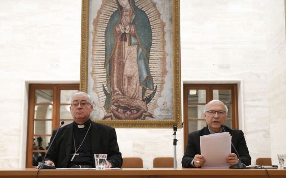 Bishop Juan Ignacio Gonzalez Errazuriz of San Bernardo, Chile, and Auxiliary Bishop Fernando Ramos Perez of Santiago, Chile, attend a press conference in Rome May 18. Bishop Gonzalez said every bishop in Chile offered his resignation to Pope Francis after
