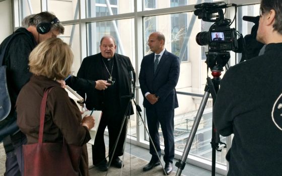 St. Paul-Minneapolis Archbishop Bernard Hebda speaks to the media alongside Thomas Abood, chairman of the archdiocese's finance council and reorganization task force, Sept. 25 at the U.S. Federal Courthouse in Minneapolis. (CNS/The Catholic Spirit)