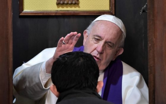 Pope Francis hears the confession of a priest at Rome's Basilica of St. John Lateran in March 2019. (CNS/Vatican Media)
