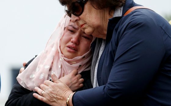 People embrace as they pay respects outside Al Noor Mosque in Christchurch, New Zealand, March 18. (CNS/Reuters/Jorge Silva)