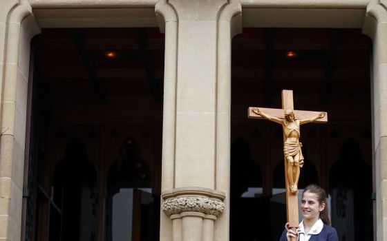 A young woman leaves St. Mary's Cathedral after a Mass in Sydney in 2013. (CNS/Reuters/Daniel Munoz)