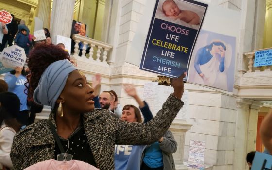 Elizabeth Koroma of Providence, Rhode Island, holds a pro-life sign in the rotunda of the Rhode Island Statehouse May 14 to protest a Senate bill aimed at expanding legal abortion in Rhode Island. The judiciary committee voted against the measure. (CNS)