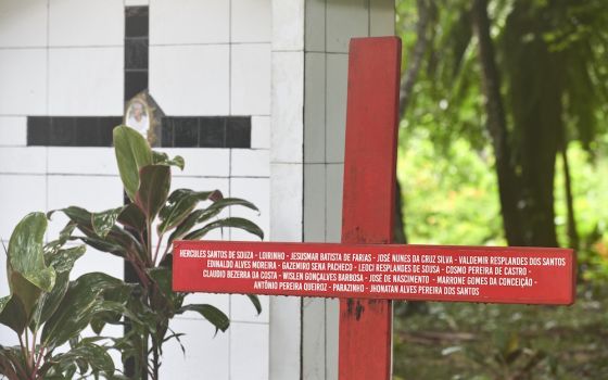 A red cross stands beside the grave of Notre Dame de Namur Sister Dorothy Stang, who was assassinated in the Brazilian Amazon in 2005. The cross bears the names of 16 local rights activists murdered since Stang's killing, and church workers say another cr